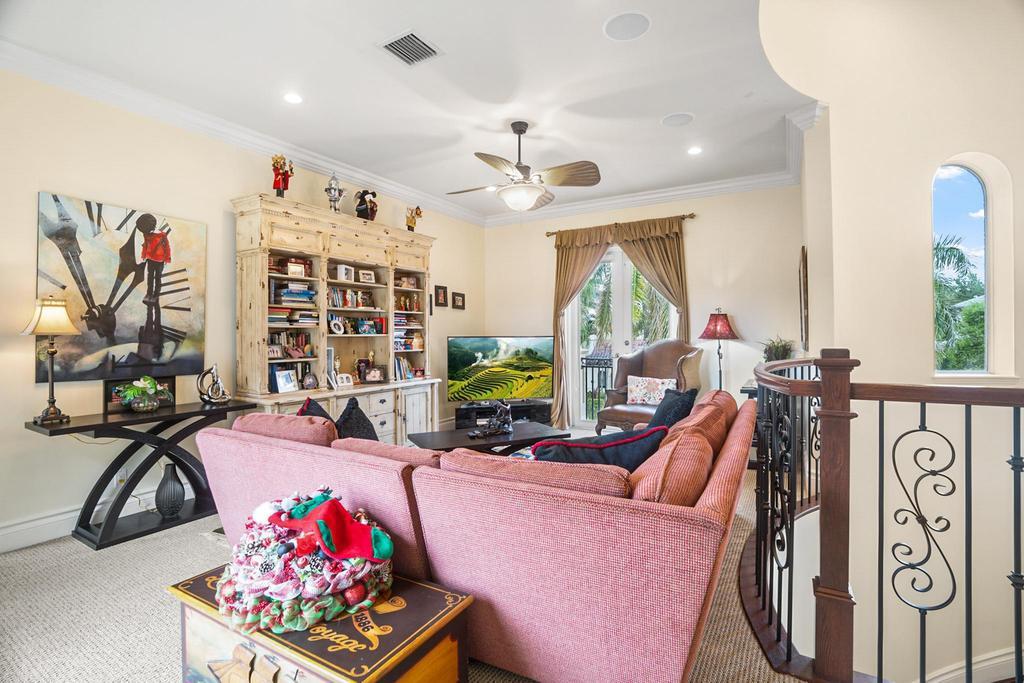 17542 Grand Este Way Boca Raton, FL 33496 - Photo 36 of 45 a living room with furniture a chandelier and a flat screen tv