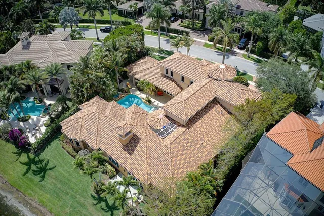a view of a house with a yard and potted plants