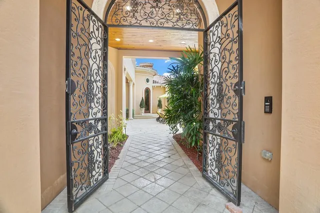 a view of a pathway of a house with potted plants