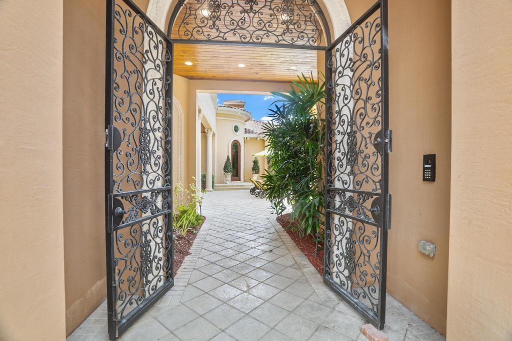 17542 Grand Este Way Boca Raton, FL 33496 - Photo 7 of 45 a view of a pathway of a house with potted plants