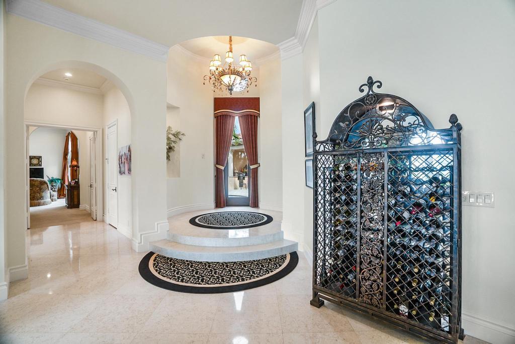 17542 Grand Este Way Boca Raton, FL 33496 - Photo 9 of 45 a dining room with a chandelier and wooden floor