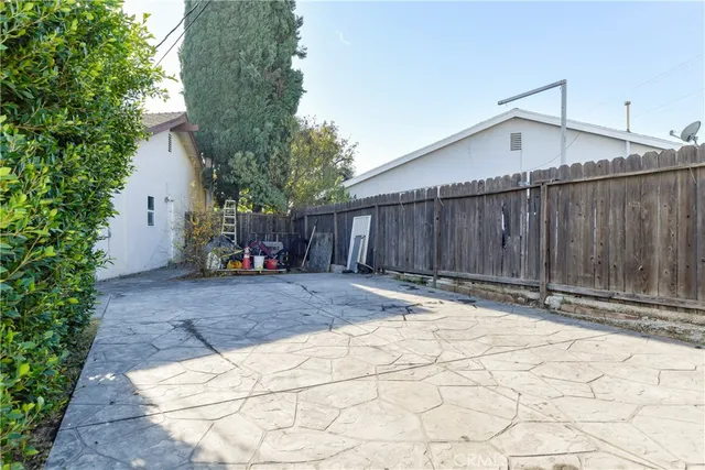 a view of a patio with furniture and a yard