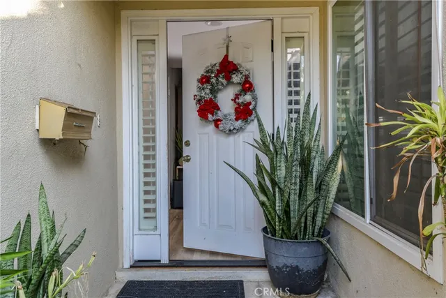 a vase of flowers sitting on a floor in front of a door