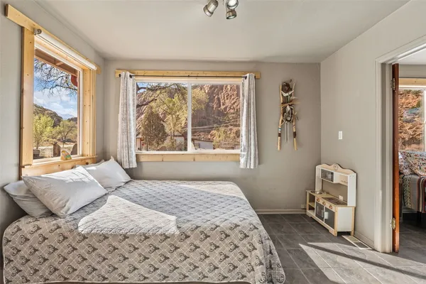 a bedroom with a large bed and a window