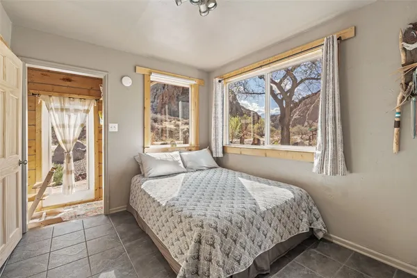 a bedroom with a large bed and a large window
