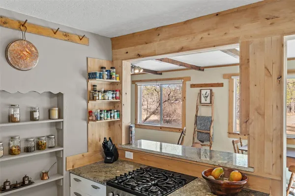 a kitchen with stainless steel appliances granite countertop a stove and a window