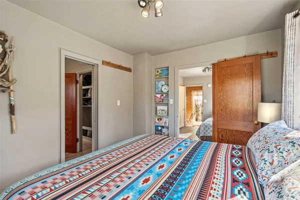 a bedroom with bed and a wooden floor