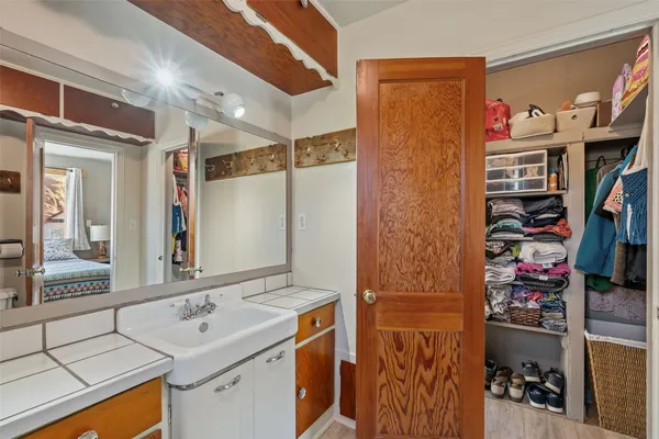 a bathroom with a sink vanity and a mirror