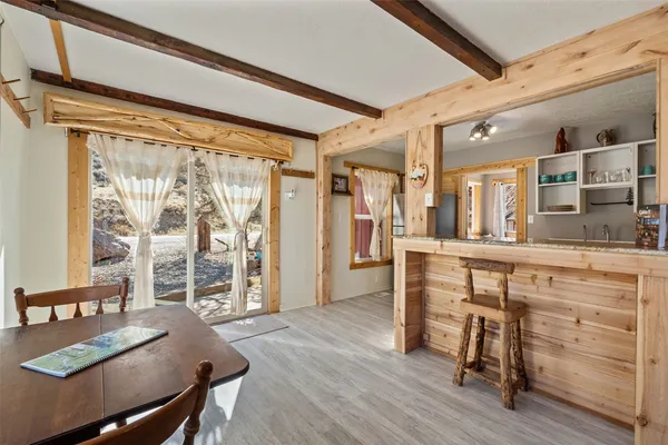 a view of a dining room with furniture and window