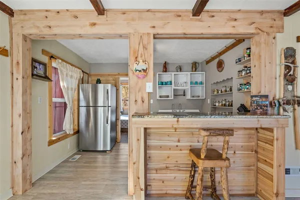 a view of a kitchen with furniture and a window