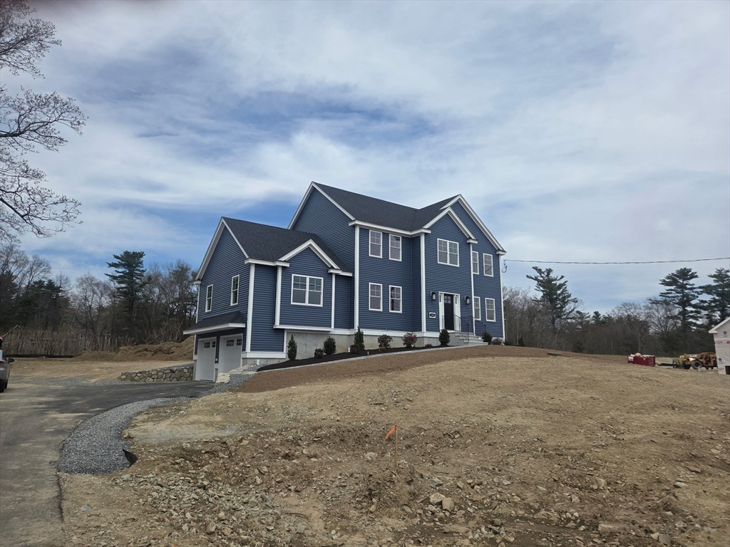 290 Salem Road Dracut, MA 01826 - Photo 15 of 16 a front view of a house with a yard and trees
