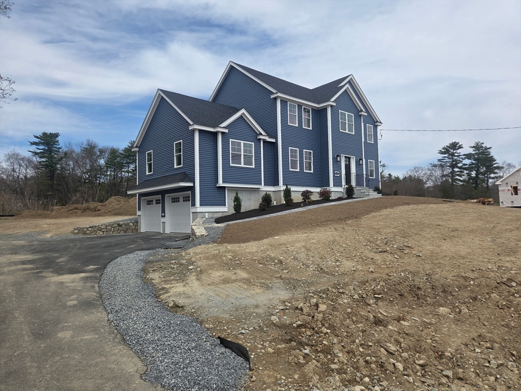 290 Salem Road Dracut, MA 01826 - Photo 16 of 16 a front view of a house with a yard and garage