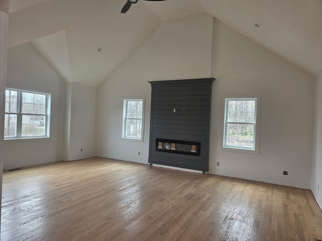 290 Salem Road Dracut, MA 01826 - Photo 4 of 16 a view of an empty room with a window and fireplace