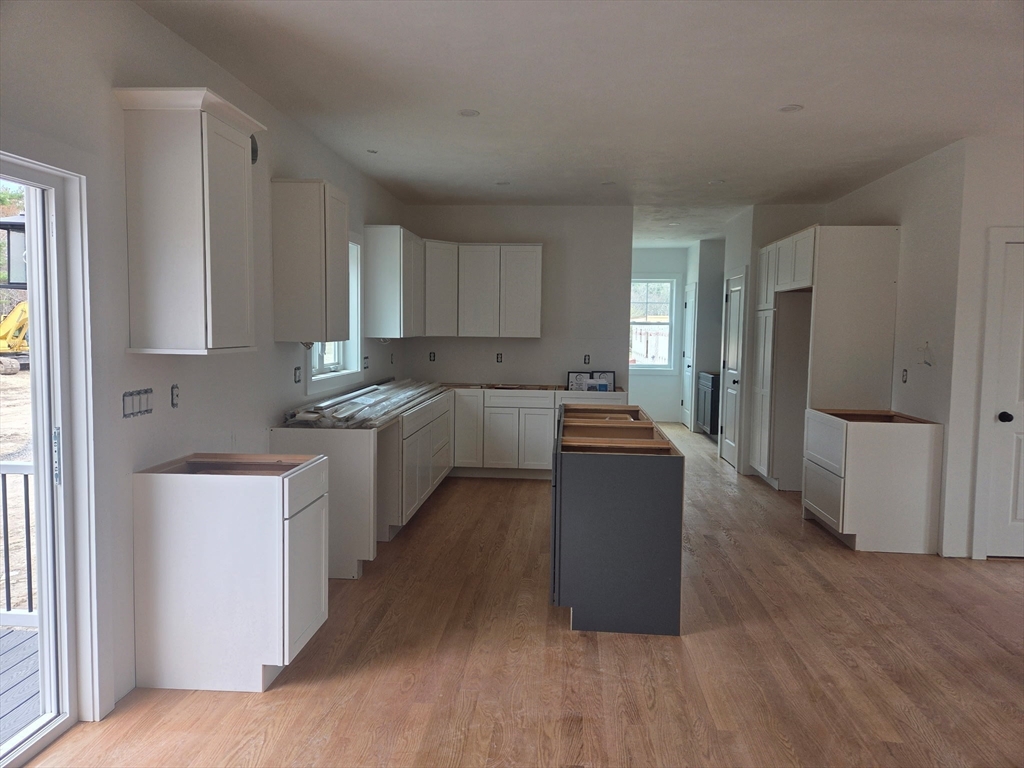 290 Salem Road Dracut, MA 01826 - Photo 6 of 16 a kitchen with a refrigerator a sink a stove a microwave and cabinets