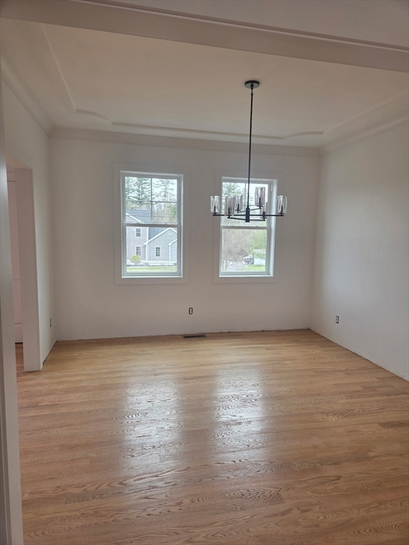 290 Salem Road Dracut, MA 01826 - Photo 7 of 16 a view of an empty room with window and wooden floor