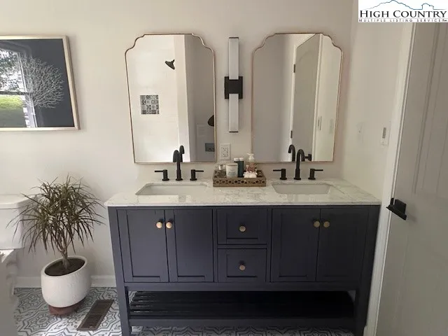 a bathroom with a toilet a sink and mirror