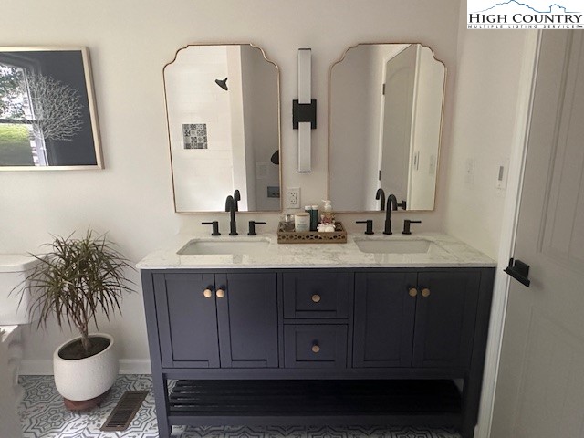 410 Cook Street Jefferson, NC 28640 - Photo 16 of 22 a bathroom with a sink and a potted plant