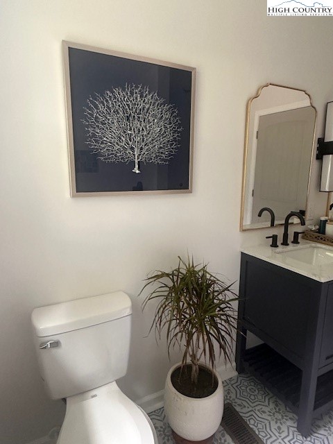 410 Cook Street Jefferson, NC 28640 - Photo 17 of 22 a bathroom with a toilet a sink and mirror