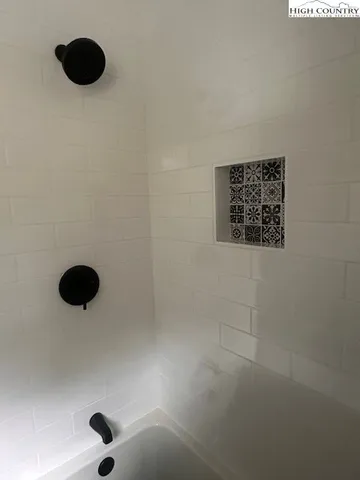 a view of a porch with chairs and potted plants