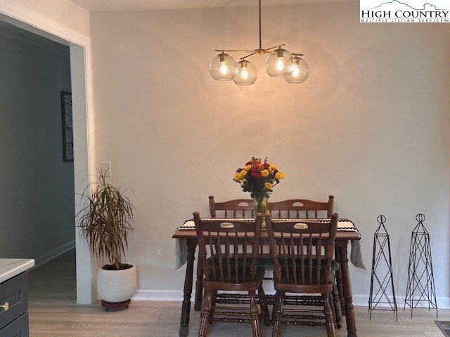 410 Cook Street Jefferson, NC 28640 - Photo 8 of 22 a view of a dining room with furniture and wooden floor