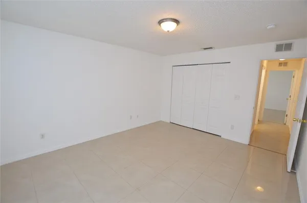 an empty room with a refrigerator