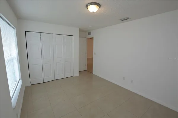 an empty room with closet area