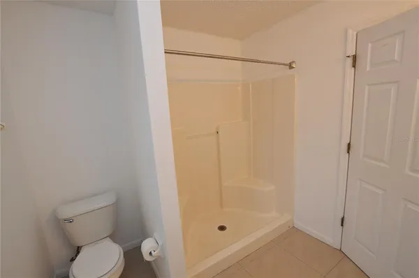 a bathroom with a shower a toilet and a sink