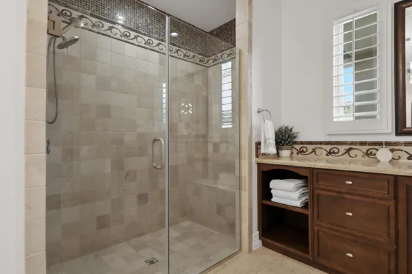 a bedroom with a bed a television and a large window