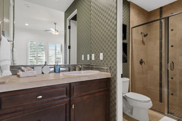 a kitchen with granite countertop a sink a stove and cabinets