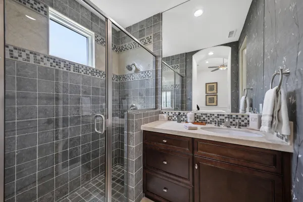 a living room with furniture fireplace and a large window