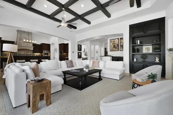 a kitchen with stainless steel appliances kitchen island granite countertop a refrigerator a stove a sink dishwasher and wooden cabinets with wooden floor