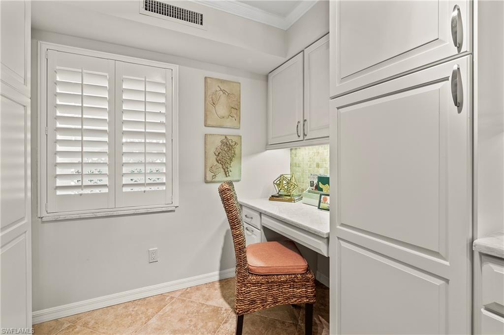 4155 Crayton Road, Unit 107 Naples, FL 34103 - Photo 18 of 36 Office with ornamental molding, built in desk, and light tile patterned flooring