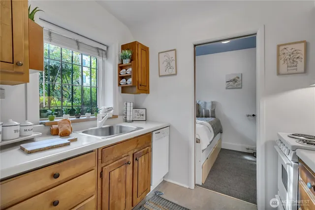 a bathroom with a sink a toilet and a window