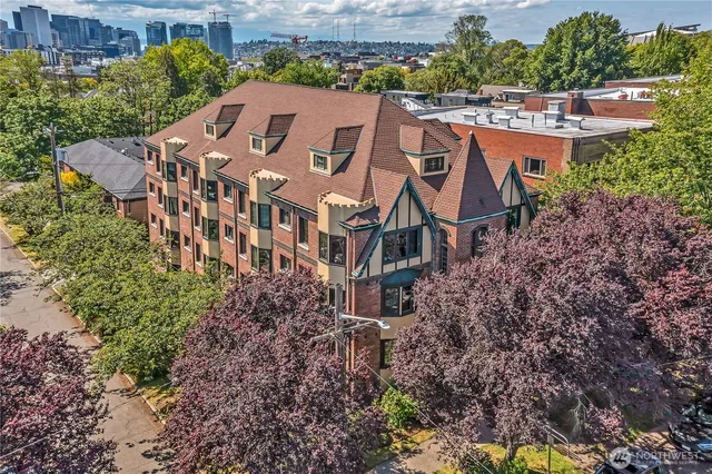 an aerial view of multiple houses with yard