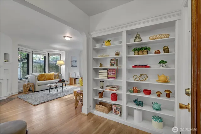 a living room with furniture and a book shelf