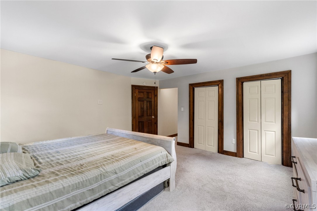 6621 Cox Road Wilsons, VA 23894 - Photo 26 of 44 a bedroom with a bed and a chandelier