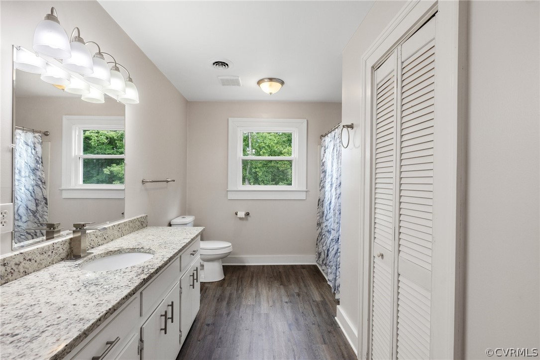 6621 Cox Road Wilsons, VA 23894 - Photo 28 of 44 a bathroom with a granite countertop sink toilet and shower