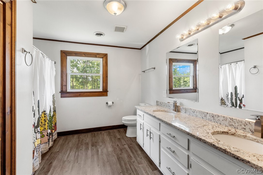 6621 Cox Road Wilsons, VA 23894 - Photo 32 of 44 a spacious bathroom with a double vanity sink and a mirror
