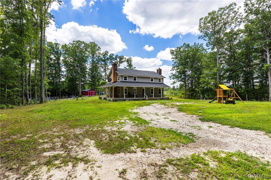 6621 Cox Road Wilsons, VA 23894 - Photo 33 of 44 a front view of a house with garden and trees