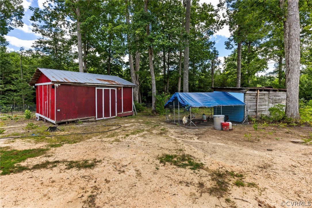 6621 Cox Road Wilsons, VA 23894 - Photo 35 of 44 a view of a backyard with a tub and fire pit