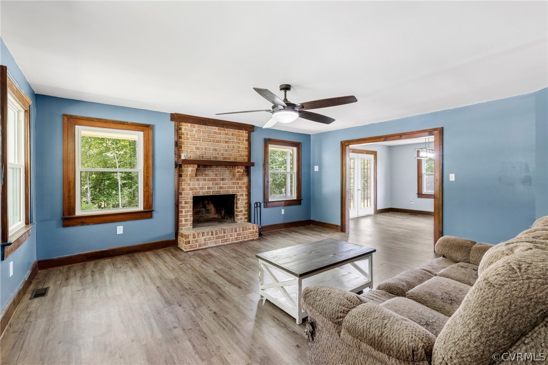 6621 Cox Road Wilsons, VA 23894 - Photo 9 of 44 a living room with furniture a window and a fireplace