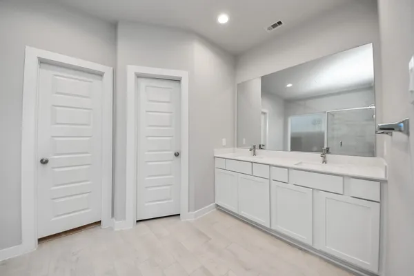 an empty room with windows and closet