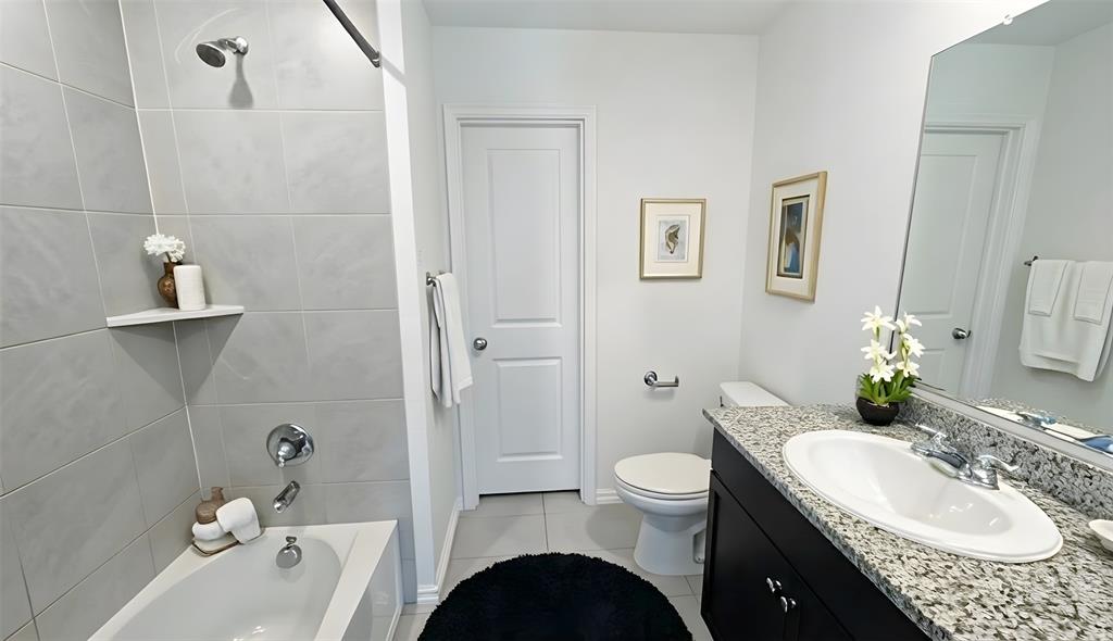 6087 Determine Lane Forney, TX 75126 - Photo 11 of 14 a bathroom with a granite countertop sink toilet and shower