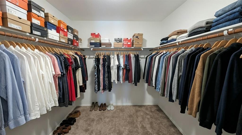 6087 Determine Lane Forney, TX 75126 - Photo 12 of 14 a view of walk in closet with clothes and shoes