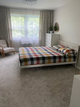 a bedroom with bed and a window