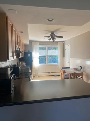 a front view of a house with a garden and trees