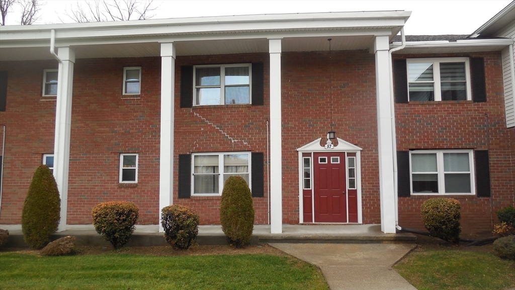 57 Colonial Circle, Unit D Chicopee, MA 01020 - Photo 2 of 19 a front view of a house