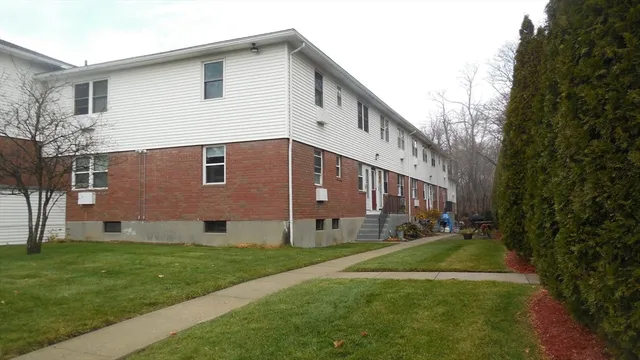 a view of house with yard
