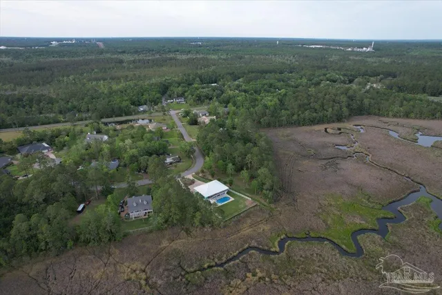 an aerial view of a house with a yard