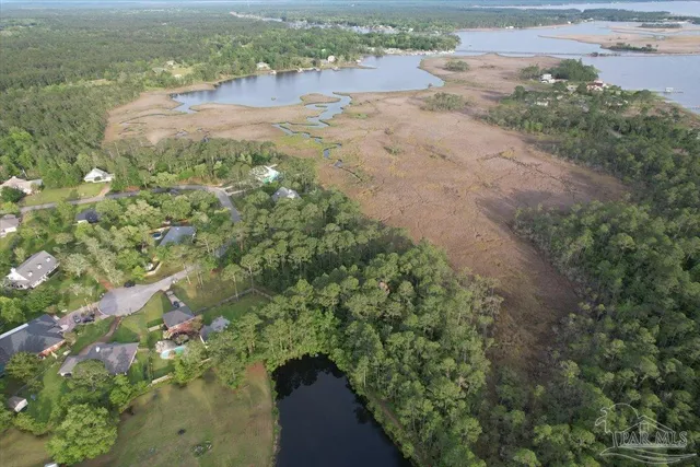 a view of a lake with beach and city space